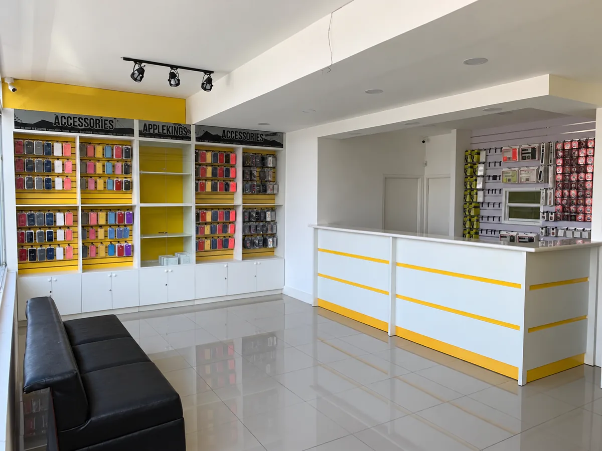 Applekings Kingston store, with yellow-striped counter and accessory displays